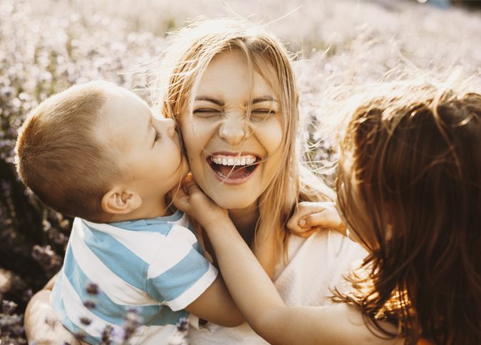 laughing mother with her two young children