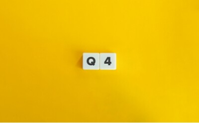 2 dice spelling 'Q4' in front of a yellow background