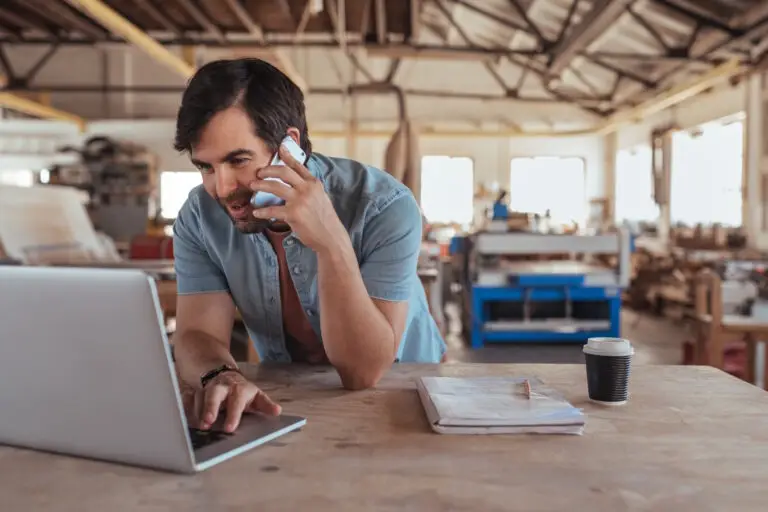 business owner talking to marketing team on phone