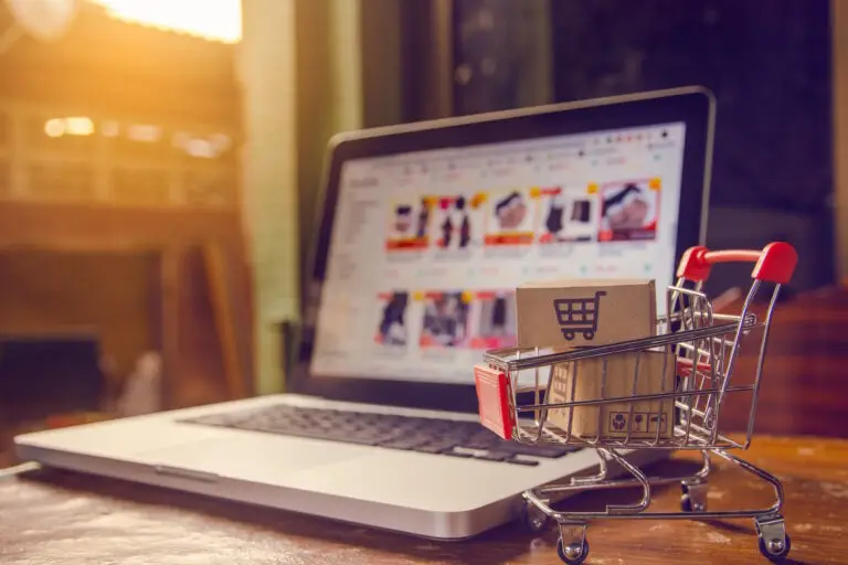 shopping cart by laptop with online shopping