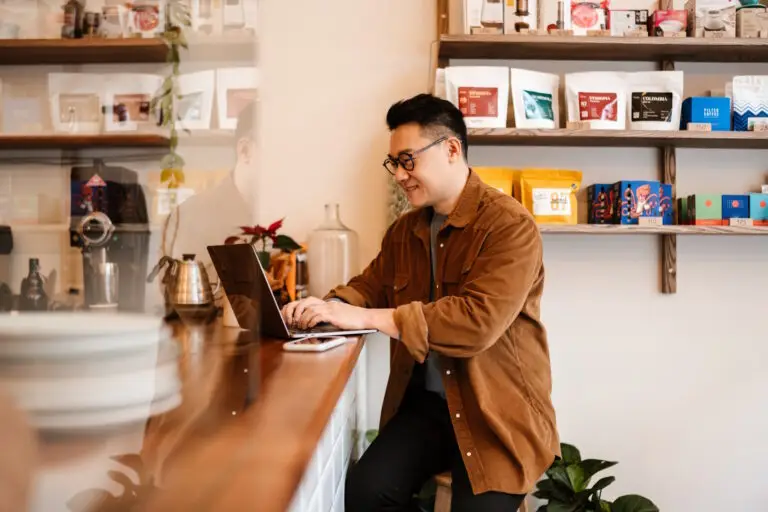 coffee shop owner working on laptop